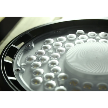 Close-up of a shower head with water droplets on a white background