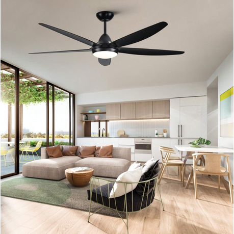 Modern living room with a ceiling fan, sofa, and kitchen in the background.