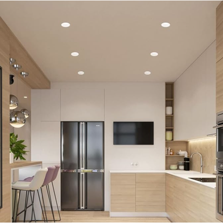 Modern kitchen with stainless steel refrigerator, TV, and wooden cabinets.