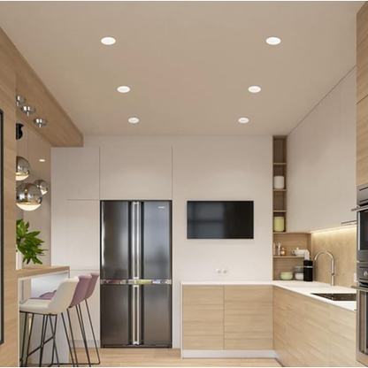 Modern kitchen with stainless steel refrigerator, TV, and wooden cabinets.