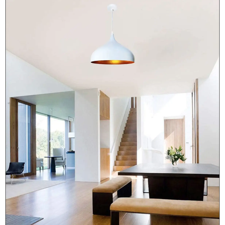 Modern interior design with a dining table, chairs, and a staircase in a bright room.