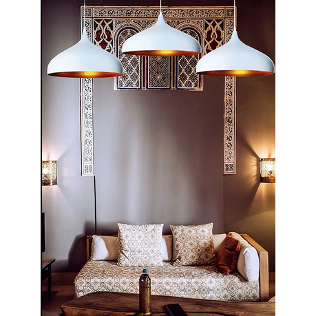 Living room with patterned sofa, decorative pillows, and hanging pendant lights.